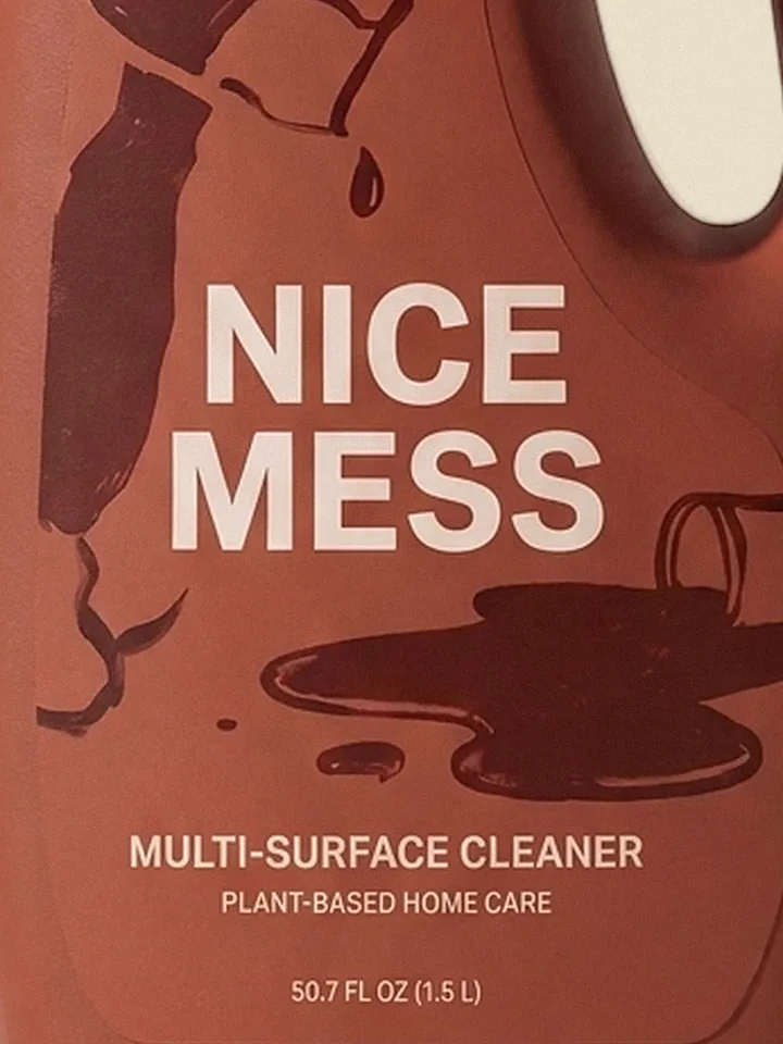 Close-up of the hand-drawn spilled-cup illustration on the Multi-Surface Cleaner label